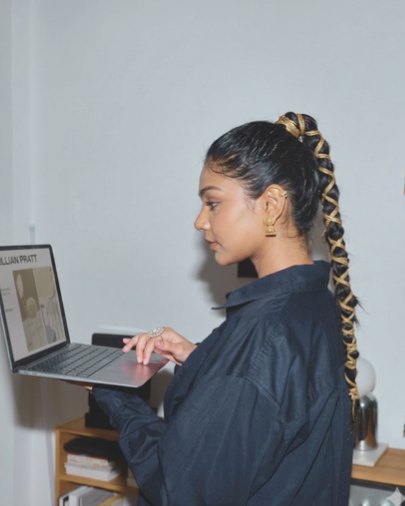 Loveleen at work, standing at a laptop
